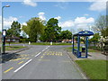 Bus stops and roundabout at the southern end of Meadow Farm Drive