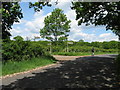 Cyclist passing joint entrance to Redland Farm and Ingrams Farm