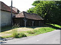 Oak framed farm building alongside Austens