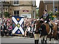 The Braw Lad dips the Burgh flag at the War Memorial