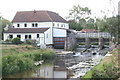 Weir and disused watermill on river Bain