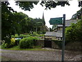 Footpath sign and church in Heath