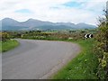 J3735 : Sharp bend in the Wateresk Road with a full panorama of the Northern Mournes by Eric Jones