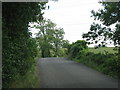 Minor road rises to cross the railway bridge