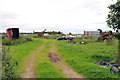 Abandoned vehicles littering a field near Allangrange Park