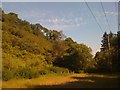 Power lines at the foot of a steep hill