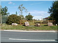 Boulders in front of a wooden fence, South Lake Drive, Coedkernew