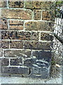 Benchmark on wall at entrance to Dorset Fencing & Shed Supplies