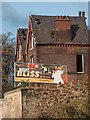 Derelict houses and incongruous advertising on Burngreave Road