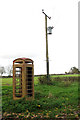 The empty shell of a K6 telephone box, Gissing