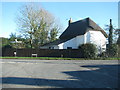 Thatched cottage by a road junction in Winterbourne Kingston