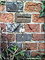 Benchmark on wall at west end of High Street