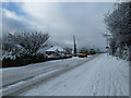 Approaching the junction of a snowy Portsdown Hill Road and Beverley Grove