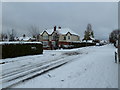 Approaching the crossroads of a snowy Portsdown Avenue and Solent Road