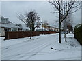 Approaching the crossroads of a snowy  Central Road and South Road