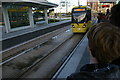 Media City tramstop: tram for Manchester arriving