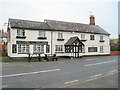 SO2090 : Sarn Inn from Village Hall by John Firth