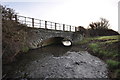 A bridge which carries the Tarka Trail over Knowl Water as seen from downstream