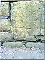 Benchmark on the wall on south side of Ben Lane