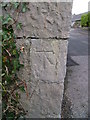 1GL benchmark on wall at village entrance, Llandegai