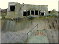 Steps going nowhere and a precariously balanced derelict house