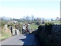 Tractor descending the steep hill down to the Mullagh River Bridge