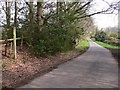 Footpath sign on road near Arundel Holt