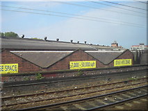 SJ8696 : Warehouses along Hyde Road, from the train by Christopher Hilton