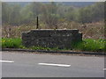 Remains of a old milk churn stand on the A5025, Rh?s Lligwy