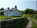 White cottage and picnic table