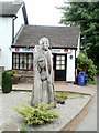 Wooden sculpture outside village shop and post office, Llangybi