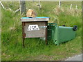 NC2414 : Post box, boulder and recumbent wheelie bin by Dave Fergusson