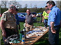 Metal detector enthusiasts discussing their finds on a farm in Pentrecelyn