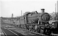 An oil-burning 2-8-0 on an Up freight at Briton Ferry station