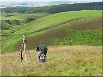 NT6168 : Surveying White Castle hill fort by M J Richardson