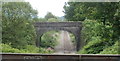 Stone railway bridge viewed across a cast-iron aqueduct, Resolven