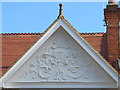 Pretty putti on the gable end of a house in Teignmouth Road, NW2