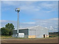 Farm building and communications mast