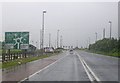 J1977 : Approaching the Nutts Corner roundabout on a rainy day by C Michael Hogan