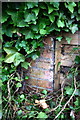 Benchmark on wall outside Ash Barn House, High Street