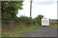 Caravan in Field Near White Sitch