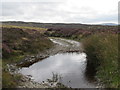 J1925 : Flooded section of a moorland track leading from the Mullaghgariff Road by Eric Jones