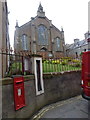 HY2508 : Stromness: parish church, postbox and barometer by Chris Downer