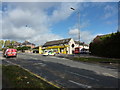 Police car and 87 bus outside yellow painted shop on Herries Road