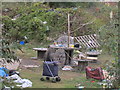 Improvised table, chairs and shelter on waste ground