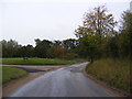 TM3253 : Ash Road & the entrance to Naunton Hall Farms by Geographer