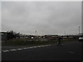 Cyclist passing the junction of Alphage Road and Gunners Way