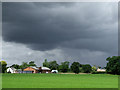 SJ6358 : Storm clouds over Cheshire farmland by Roger  D Kidd