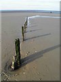 TF7745 : Worn groynes on Brancaster beach by Steve  Fareham