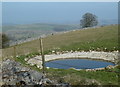 SK1470 : Dewpond above Taddington by Andrew Hill